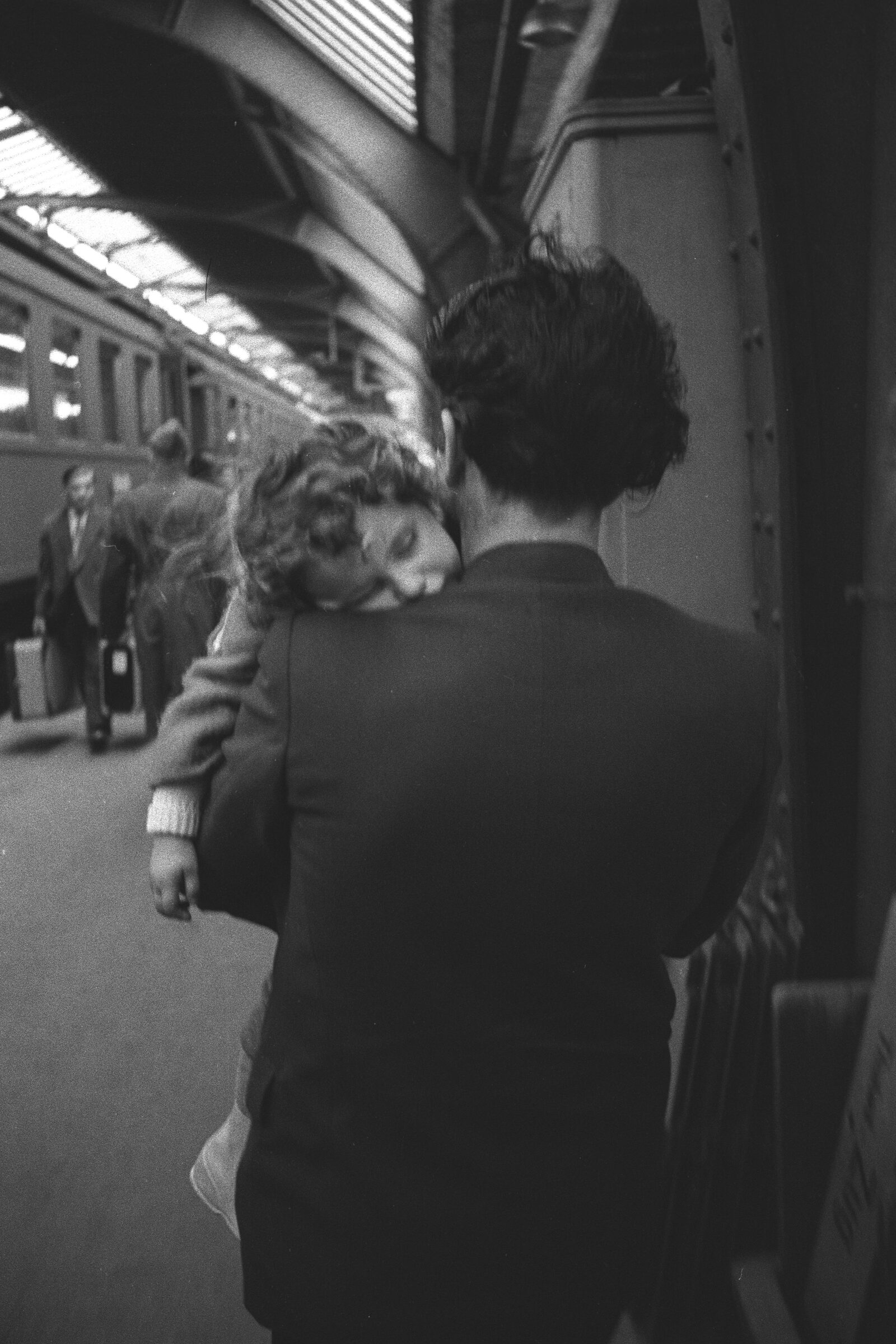 An Italian guest worker carrying a small child on his shoulder in the concourse of Zurich main station