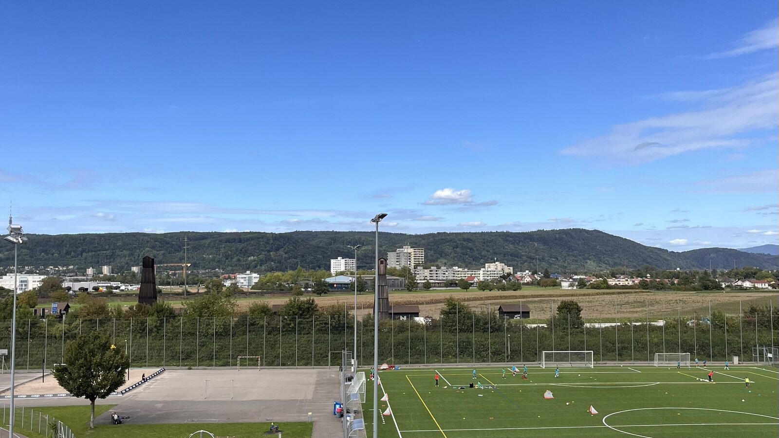 A view over the Laengi housing estate in Pratteln with floodlit football pitches in the foreground