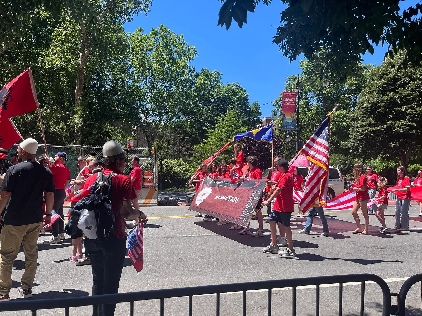 Familien und Jugendgruppen mit albanischen, kosovarischen und amerikanischen Flaggen bei der Parade 2026